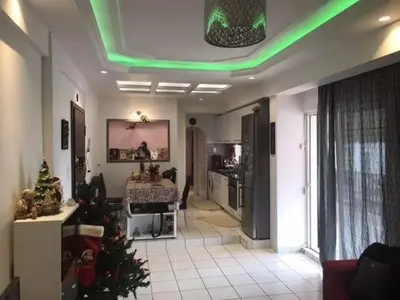 a living room with a christmas tree and a kitchen at Enjoy the silence and view in Athens