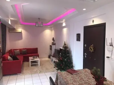 a living room with a christmas tree and pink lights at Enjoy the silence and view in Athens