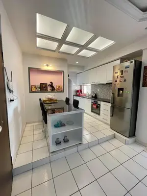 a kitchen with a refrigerator and a table in it at Enjoy the silence and view in Athens