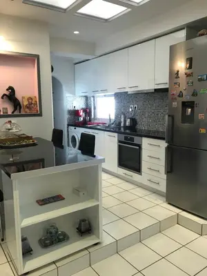 a kitchen with white cabinets and a stainless steel refrigerator at Enjoy the silence and view in Athens