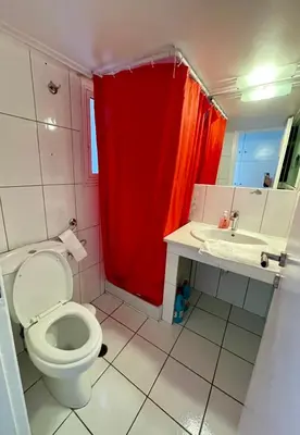 a bathroom with a toilet and a red shower curtain at Enjoy the silence and view in Athens