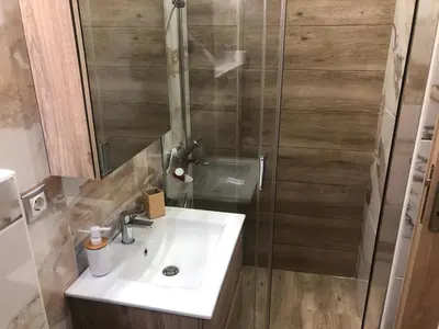 a bathroom with a sink and a shower at Royal Blue Grand Suite No 1 in Piraeus