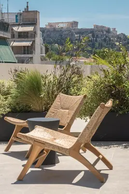 a pair of chairs and a table on a patio at Ceramian Athens in Athens