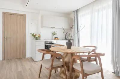 a kitchen with a wooden table and chairs in a kitchen at Ceramian Athens in Athens