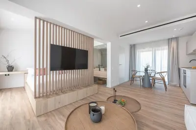 a living room with a television and a table at Ceramian Athens in Athens