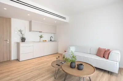 a white living room with a white couch and a table at Ceramian Athens in Athens