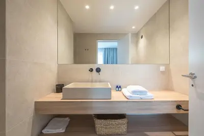 a bathroom with a sink and a mirror at Ceramian Athens in Athens