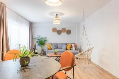 a living room with a couch and a table and chairs at Boho Chic Apartment Under Acropolis in Athens