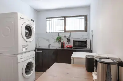 a kitchen with a washing machine and a microwave at Boho Chic Apartment Under Acropolis in Athens