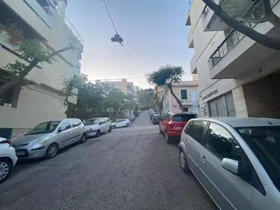 a row of cars parked on a city street at Boho Chic Apartment Under Acropolis in Athens