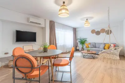 a living room with a table and chairs and a couch at Boho Chic Apartment Under Acropolis in Athens