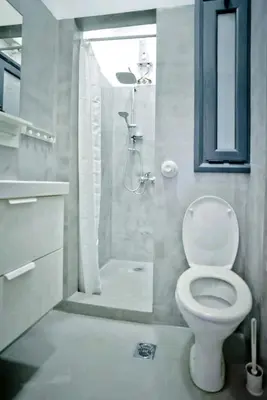 a white bathroom with a toilet and a shower at The old Tailor Factory White Room in Athens