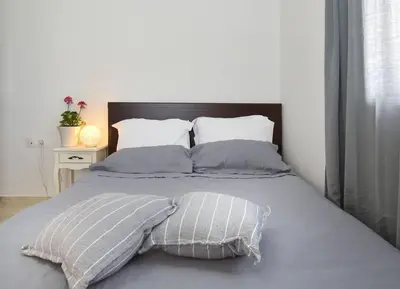 a bed with two pillows on top of it at Cozy Bright Studio in Athens