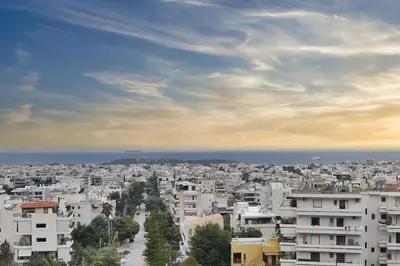 a view of a city with buildings and the ocean at Cozy Bright Studio in Athens