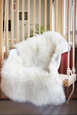 a white chair in a crib with a white blanket at Stylish living by Acropolis (Monastiraki 5) in Athens