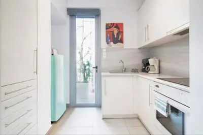 a kitchen with white cabinets and a green refrigerator at Stylish living by Acropolis (Monastiraki 5) in Athens