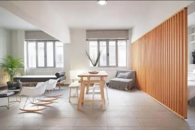a living room with a couch a table and chairs at Stylish living by Acropolis (Monastiraki 5) in Athens