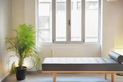 a bench in a room with a window and two plants at Stylish living by Acropolis (Monastiraki 5) in Athens