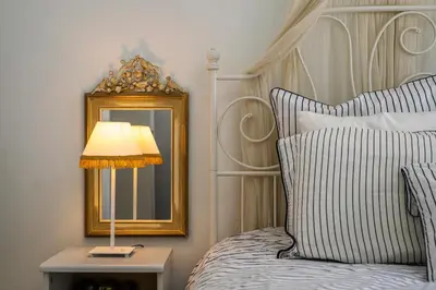 a bedroom with a bed with a lamp and a mirror at Luxury Apartment Marina Zeas Piraeus - Balcony - Near Port in Piraeus