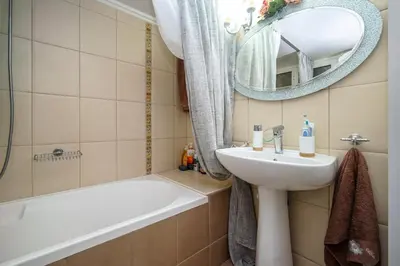 a bathroom with a sink and a tub and a mirror at Luxury Apartment Marina Zeas Piraeus - Balcony - Near Port in Piraeus