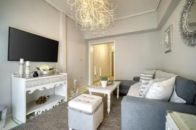 a living room with a couch and a tv at Luxury Apartment Marina Zeas Piraeus - Balcony - Near Port in Piraeus
