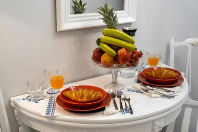 a table with a bowl of fruit and plates of food at Luxury Apartment Marina Zeas Piraeus - Balcony - Near Port in Piraeus