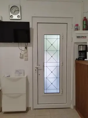a door with a glass window in a kitchen at Cozy Studio in Athens