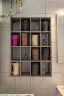 a shelf with many different colored baskets on a wall at Alimos - Sea View Apartment in Athens