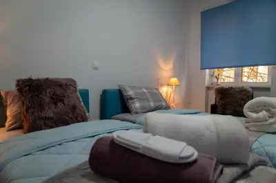 a living room with two beds and a couch at Alimos - Sea View Apartment in Athens