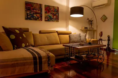 a living room with a couch and a table at Alimos - Sea View Apartment in Athens