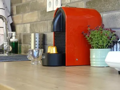 a red toaster sitting on top of a kitchen counter at Zeus Bright & New Apartment - 25' walk to the Acropolis in Athens