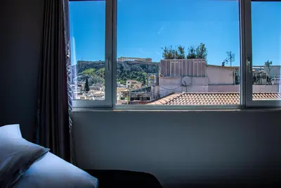 a bedroom window with a view of a city at Athens Hills in Athens