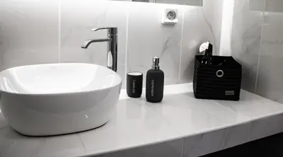 a bathroom with a sink and two bottles on a counter at Athens Hills in Athens
