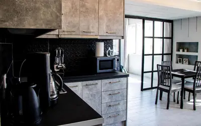a kitchen with a counter and a table with a microwave at Athens Hills in Athens