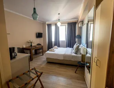 a hotel room with a bed and a chair at Monastiraki 309 SuperHost Hub in Athens