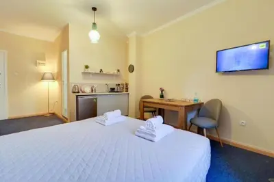 a hotel room with a white bed and a desk at Monastiraki 309 SuperHost Hub in Athens