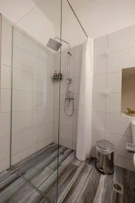 a shower with a glass door in a bathroom at Monastiraki 309 SuperHost Hub in Athens