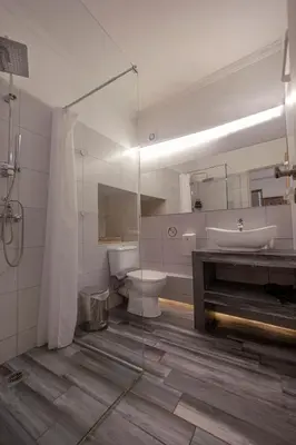 a bathroom with a sink and a toilet and a tub at Monastiraki 309 SuperHost Hub in Athens