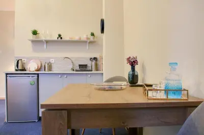 a kitchen with a wooden table and a counter top at Monastiraki 309 SuperHost Hub in Athens