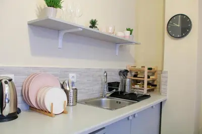 a kitchen counter with a sink and a clock at Monastiraki 309 SuperHost Hub in Athens