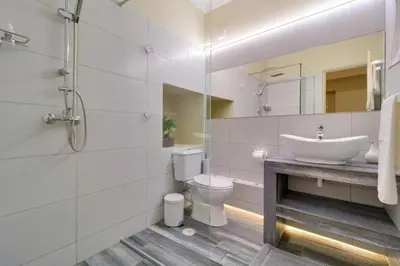 a white bathroom with a sink and a toilet at Monastiraki 309 SuperHost Hub in Athens