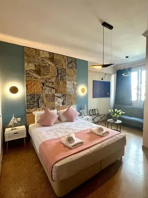 a bedroom with a large bed with towels on it at Monastiraki 510 SuperHost Hub in Athens
