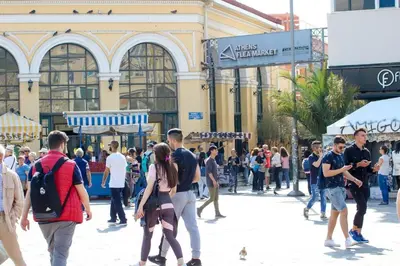 a crowd of people walking on a street in front of a building at Monastiraki 510 SuperHost Hub in Athens