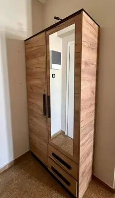 a wooden cabinet with a mirror in a room at Monastiraki 510 SuperHost Hub in Athens
