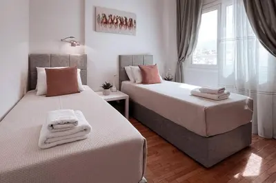 a bedroom with two beds and a window at Penthouse - Amazing View in the Center of Athens in Athens