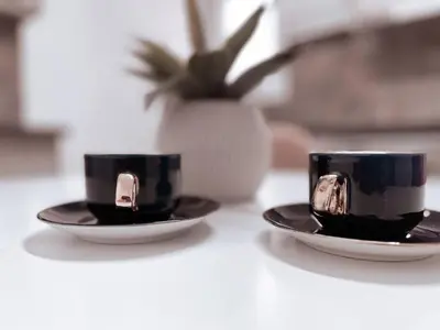 two black and white coffee cups sitting on a table at Penthouse - Amazing View in the Center of Athens in Athens