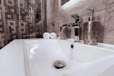 a bathroom sink with water running from a faucet at Penthouse - Amazing View in the Center of Athens in Athens