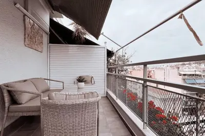 a balcony with a chair and a table on a balcony at Penthouse - Amazing View in the Center of Athens in Athens