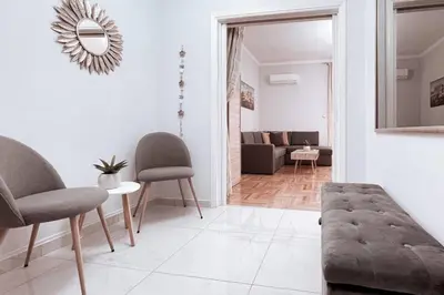 a living room with two chairs and a couch at Penthouse - Amazing View in the Center of Athens in Athens