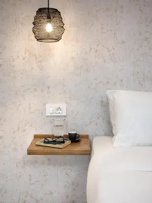 a bedroom with a bed and a nightstand with a bed sidx sidx at Seaside Nestie by BluPine in Athens